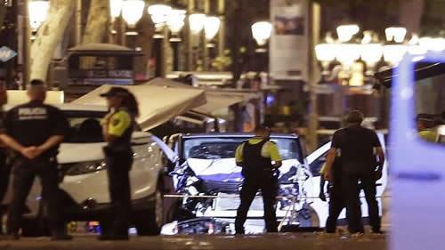 Police officers stand next to the van involved on an attack in Las Ramblas in Barcelona, Spain