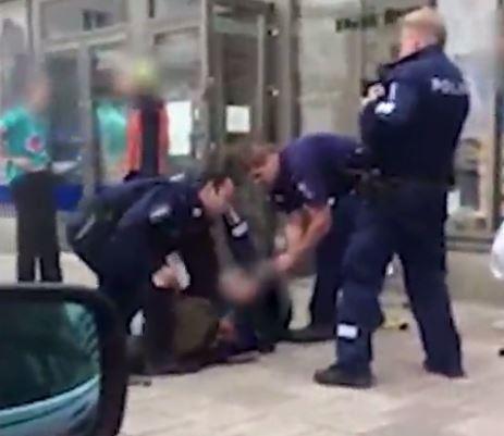 This is the moment the suspect was shot and fell to the floor before police detained him