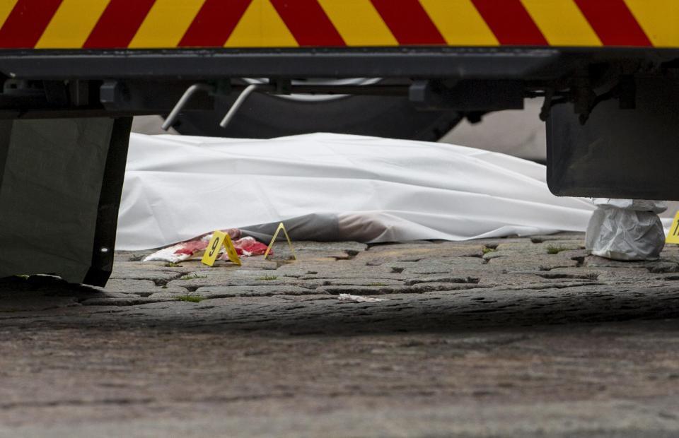 The shrouded body of a stabbing victim on the Market Square