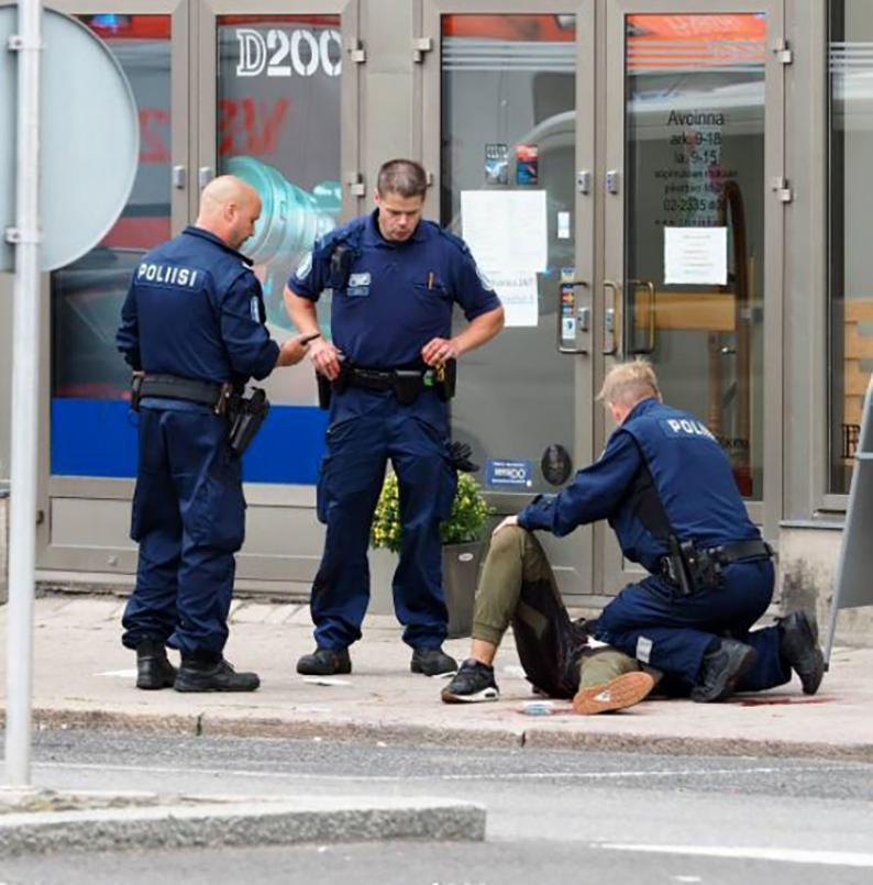 The 'suspect' is seen being treated by police after falling to the floor