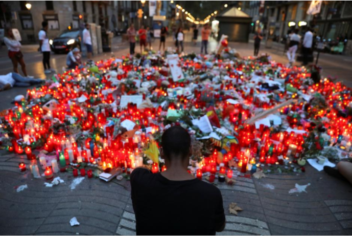  People gather at an impromptu memorial where a van crashed into pedestrians at Las Ramblas, in Barcelona, Spain.