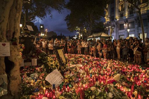 People put flowers at the Memorial to victims