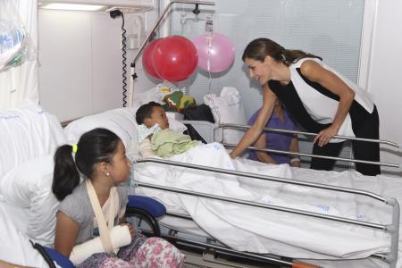 Spain's Princess Letizia speaks with one of the victims of
