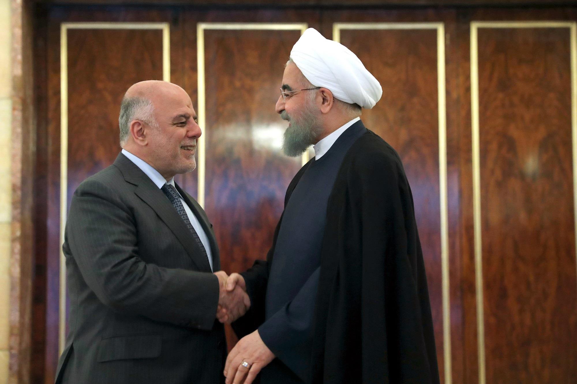 Iranian Regime 's President Hassan Rouhani with Iraqi Prime Minister Haidar al-Abadi in Tehran on June 20, 2017. 