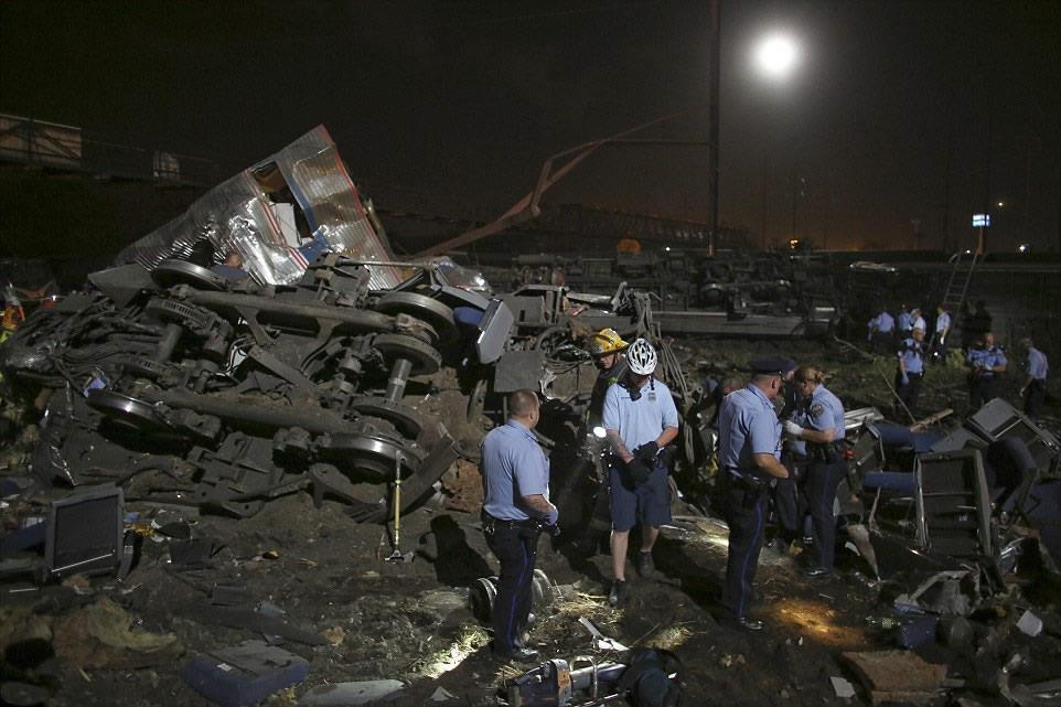 Split in two, Seats can be seen strewn on the ground having been thrown from the wreck of the carriage which split in two during the crash