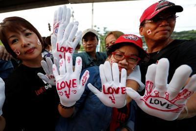Yingluck supporters had gathered outside the court on Friday where around 4,000 police had been deployed. Some wore white gloves with the word “love” on them.