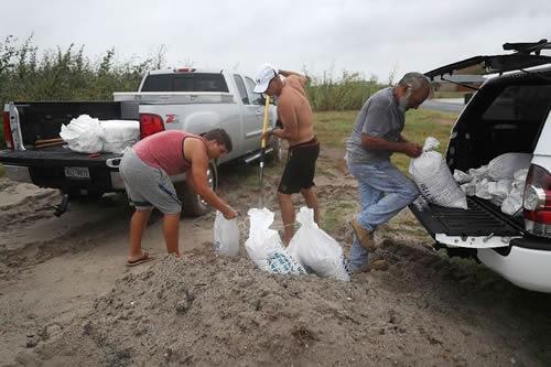 Residents in Corpus Christi, Texas who have decided not to leave have been filling sandbags to prepare for Hurricane Harvey