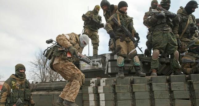 A Russia-backed rebel jumps off a tank in Debaltseve, Ukraine