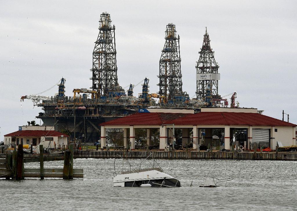 A sunken boat lies submerged in front of an oil rig after Hurricane Harvey hit Port Aransas, Texas