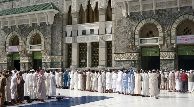 Worshippers pray outside the Grand Mosque in Mecca on August 27, 2017 ahead of the annual hajj pilgrimage 