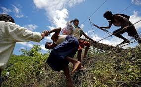 Rohingya people cross the border fence to enter inside Bangladesh border, in Cox's Bazar