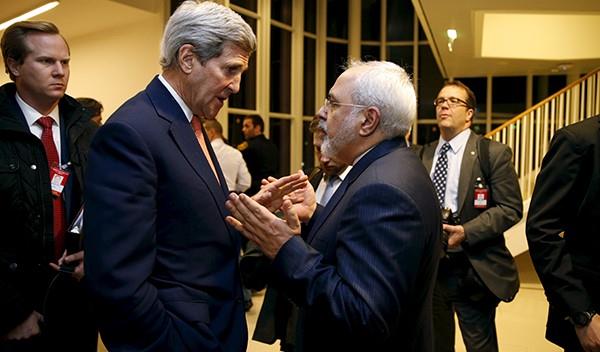 Secretary of State John Kerry talks with Iranian Foreign Minister Mohammad Javad Zarif after the International Atomic Energy Agency (IAEA) verified that Iran has met all conditions under the nuclear deal, in Vienna January 16, 2016. 