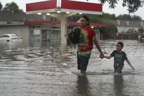 Residents walked through high waters as they evacuated their homes after the flooding. More rain is expected