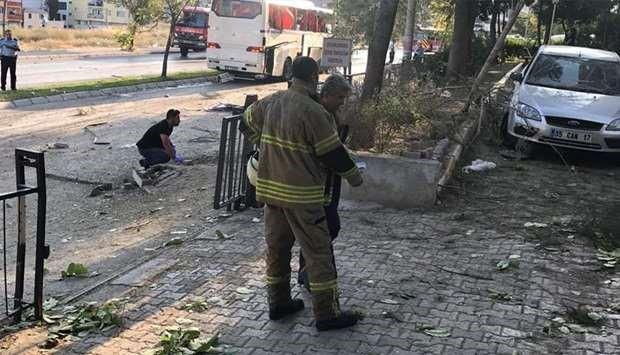 The force of the blast appeared to have blown out some of the bus's panels, and the nearby street was littered with debris.