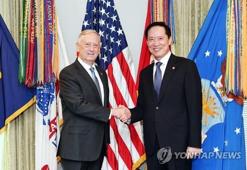 South Korean Defense Minister Song Young-moo (R) shakes hands with U.S. Defense Secretary Jim Mattis during their meeting at the Pentagon near Washington on Aug. 30, 2017, in this photo provided by Song's ministry