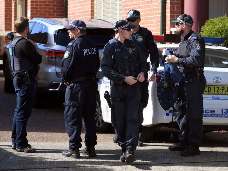 Australian Police emerge from a block of flats in the Sydney 