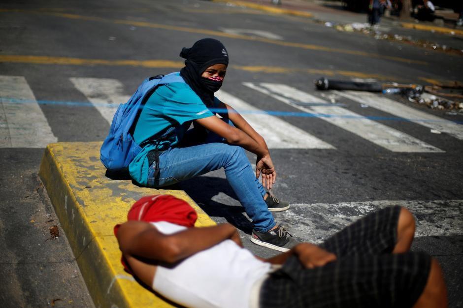 Demonstrators rest as they block a street at a rally against Venezuela's President Nicolas Maduro's government in Caracas, Venezuela August 8, 2017.