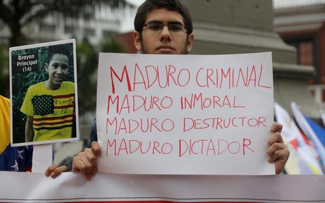  A demonstrator holds a sign that reads