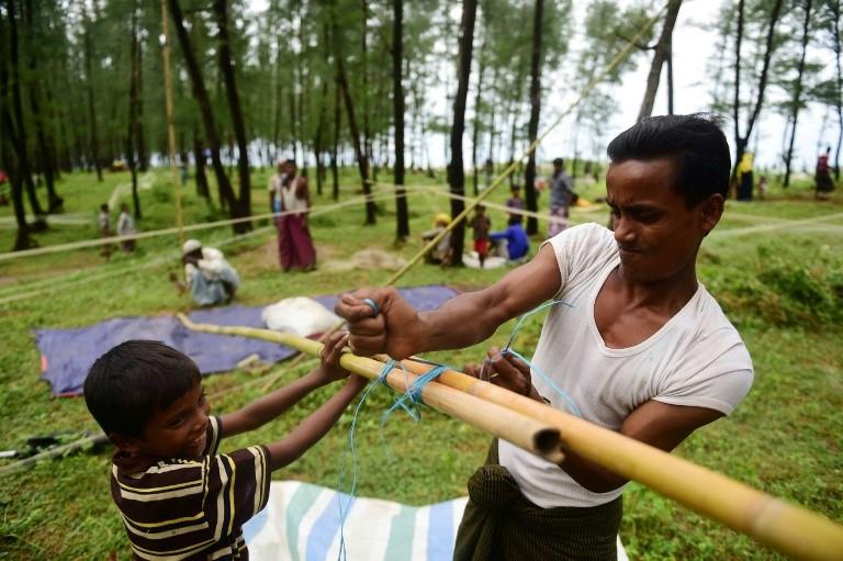 Rohingya Muslim refugees build temporary makeshift shelters, after crossing the border from Myanmar, in the Bangladeshi town of Teknaf on September 10, 2017