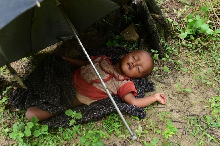  A Rohingya Muslim child sleeps after crossing the border from Myanma