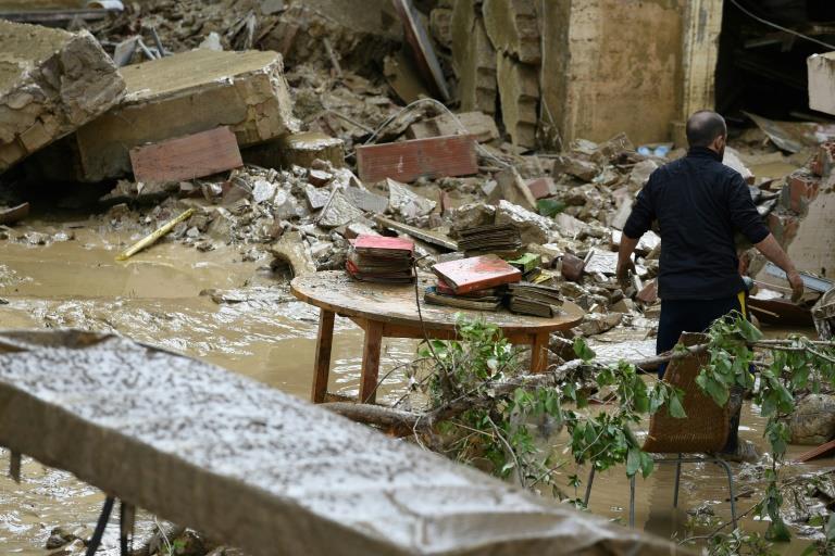  A man works to empty his home in the Livorno area, flooded after heavy rain