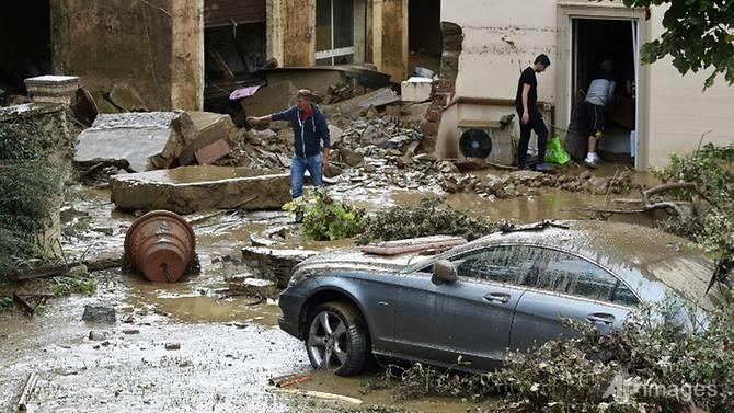 People empty a house in the Livorno area, flooded after heavy rain, on Sep 10, 2017.