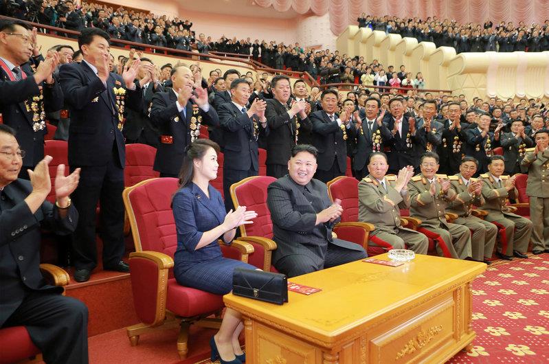 North Korean leader Kim Jong Un claps during a celebration for nuclear scientists and engineers who contributed to a hydrogen bomb test