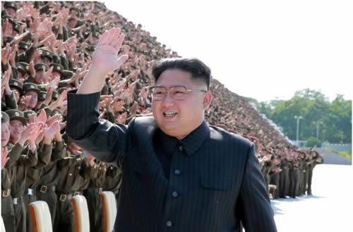 North Korean leader Kim Jong Un waves at a photo session with attendants in the fourth Active Secretaries of Primary Organization of KPA 