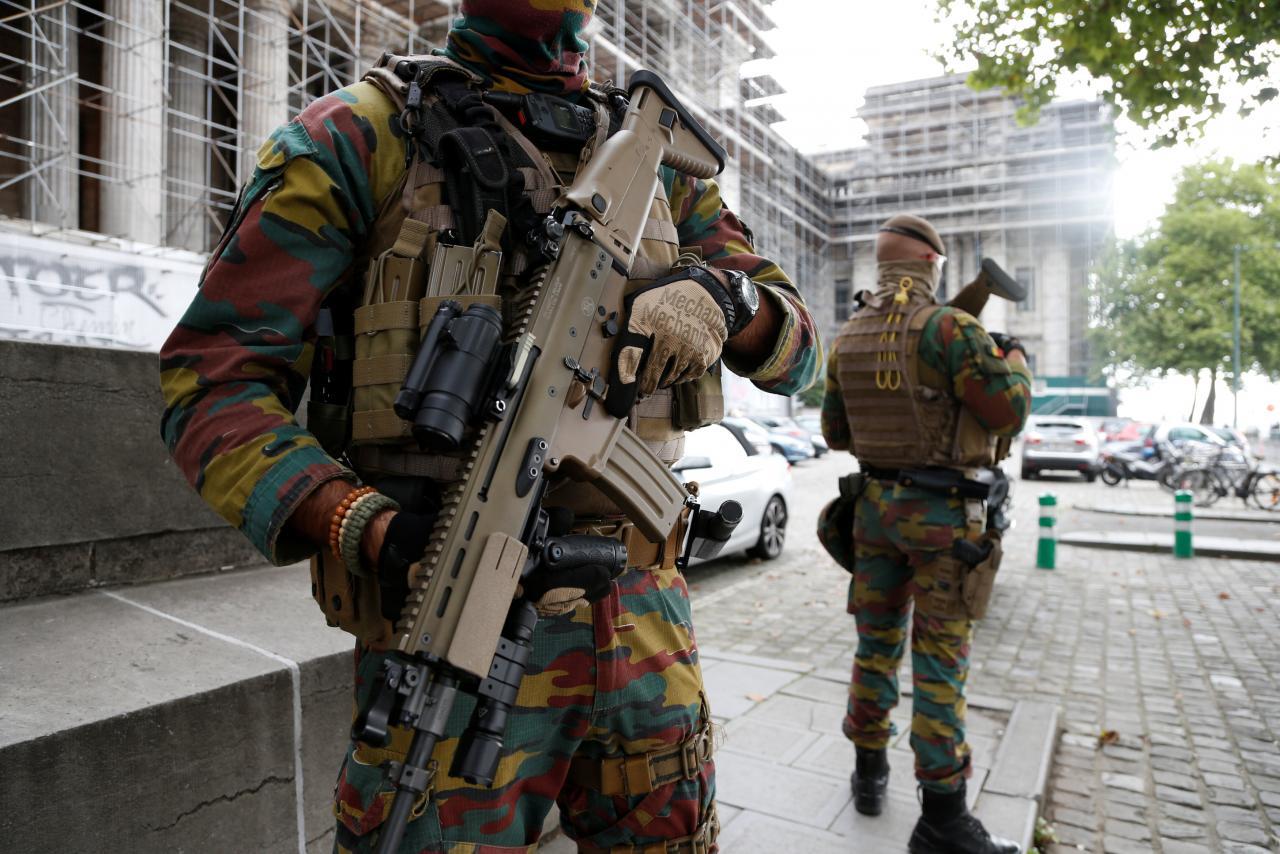 Belgian soldiers stand guard as they patrol outside the Palace of Justice in Brussels, Belgium, September 5