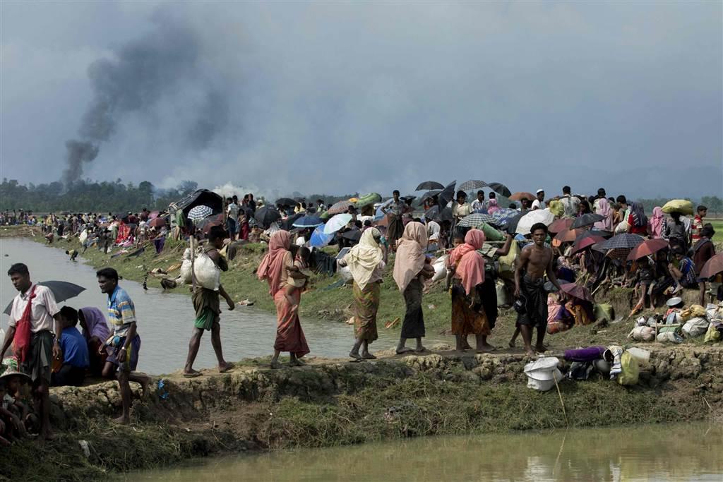 Smoke billows above what is believed to be a burning village in Myanmar's Rakhine state as members of the Rohingya Muslim minority
