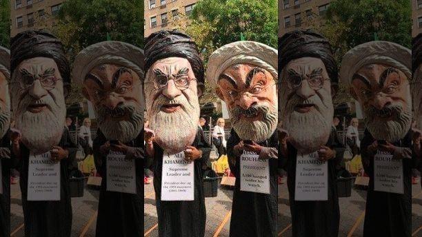 Iranian protestors gather outside the UN with caricature's of their President Rouhani