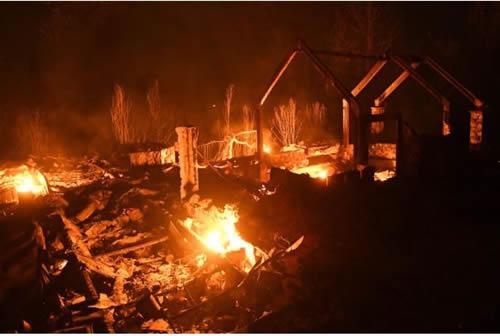 Flames from the Ponderosa Fire burn a home east of Oroville, California, U.S. August 29, 2017