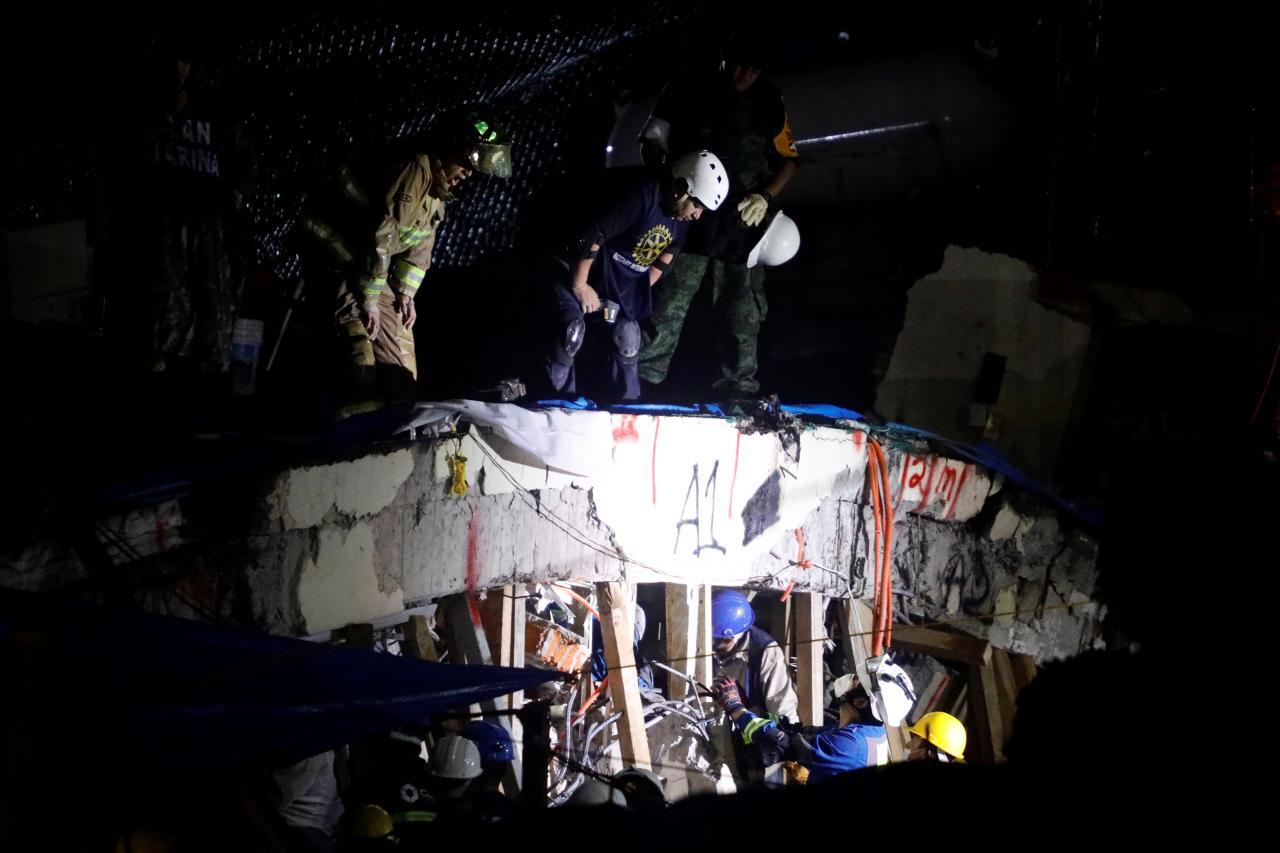 Rescue workers search through the rubble for students at Enrique Rebsamen school after an earthquake in Mexico City, Mexico, September 20, 2017