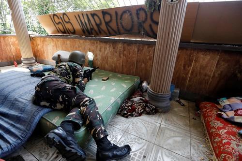 A Filipino soldier lies on a mattress at their combat position in a house July 1