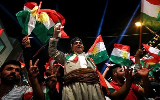 Iraqi Kurds celebrate while urging people to vote in the upcoming independence referendum in Arbil.