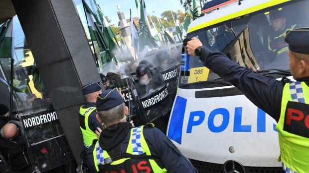 Police use pepper spray to stop far-right Nordic Resistance Movement marchers trying to change