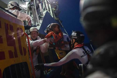 A deal with Turkey cut the flow across the Aegean Sea to Greece but other routes have since seen a resurgence in migrants. Red Cross and Saviour volunteers are evacuating refugees from a boat to a ship.