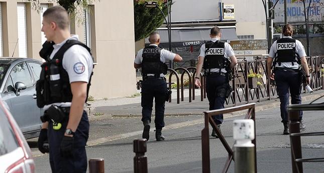 French police officers walk as two people have been detained after a possible explosives laboratory