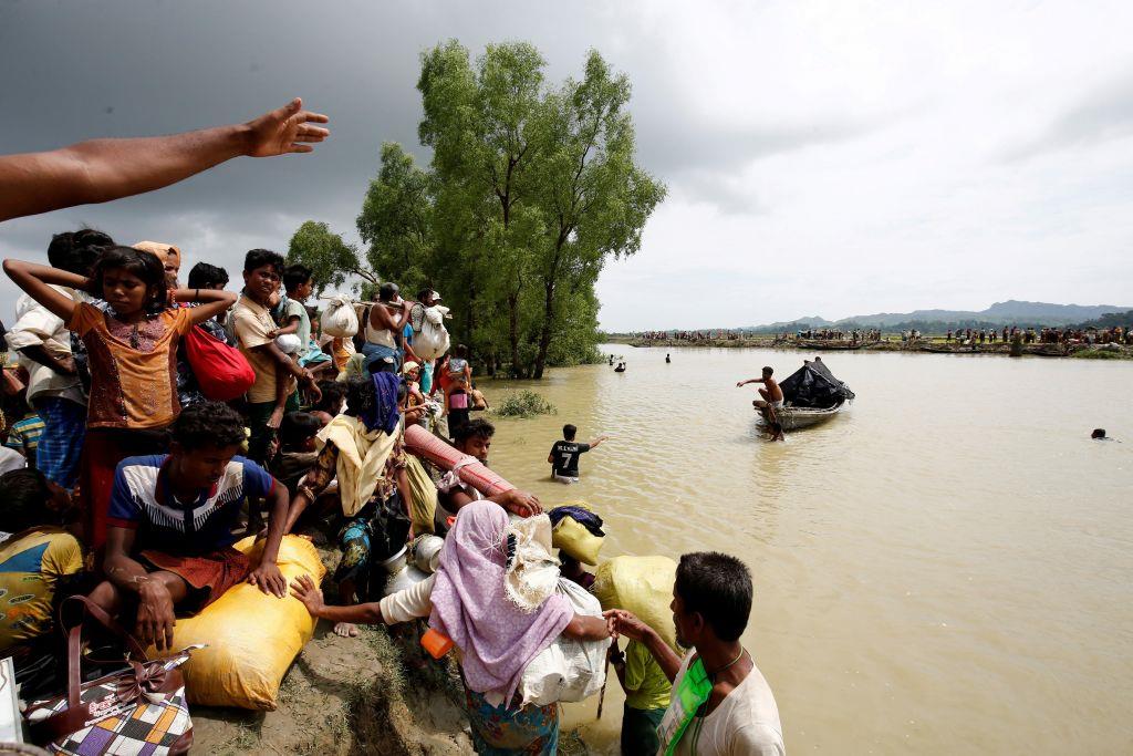 Rohingya refugees wait for boat to cross a canal after crossing the border through the Naf river in Teknaf, Bangladesh, Sept 7,2017