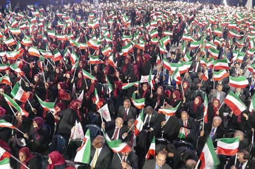 A jubilant grand gathering of PMOI members and hoisting the flag of Iran