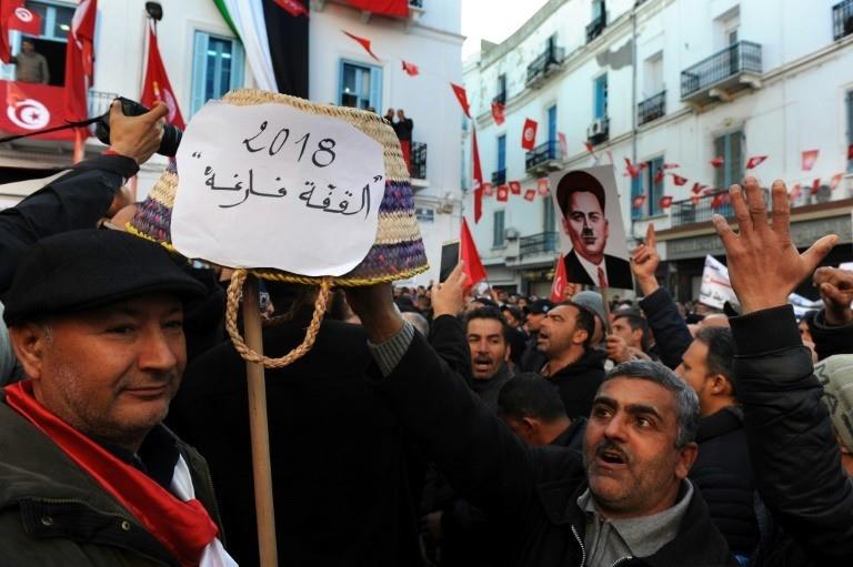 Anis MILITunisian workers hold up a basket with text reading in Arabic: 'the basket is empty' while shouting slogans against the government in front of the Tunisian General Labour Union (UGTT) headquarters in Tunis