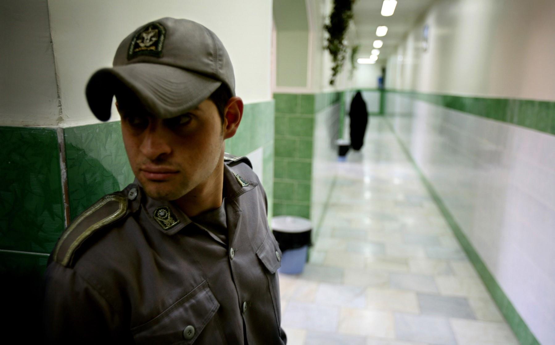 A prison guard stands along a corridor in Tehran’s Evin Prison.
