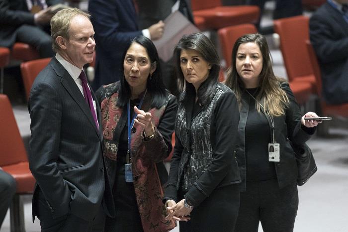 British Ambassador to the United Nations Matthew Rycroft, left, speaks to American Ambassador to the United Nations Nikki Haley before the start of a Security Council meeting on the situation in Iran, Friday, Jan. 5, 2018 at United Nations headquarters.