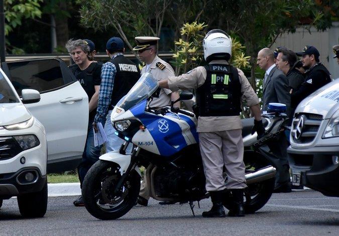 Former Vice President Amado Boudou, left, and a business partner were escorted to vehicles transporting them to court in Buenos Aires in November