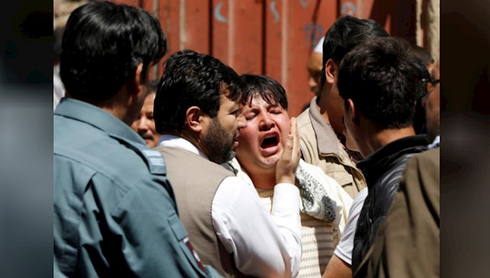 A man reacts as others comfort him at the site of a suicide attack in Kabul, Afghanistan April 22, 2018