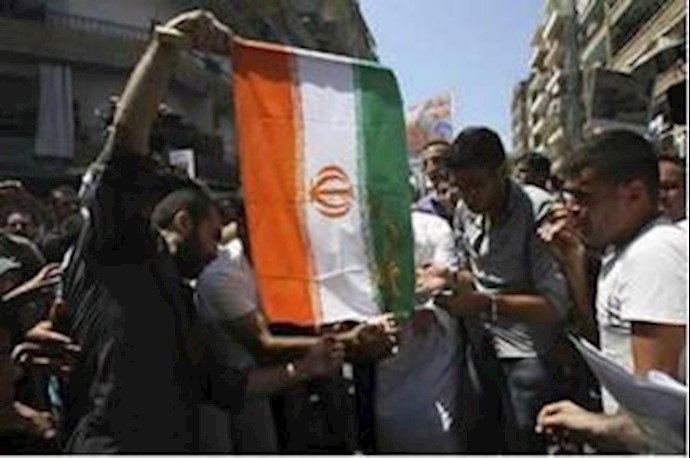 Setting aflame clerical regime’s flag and pictures of Ahmadinejad: Syrian youths