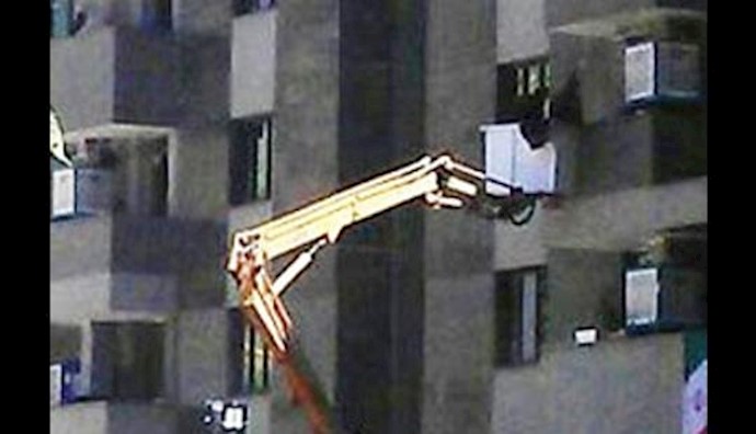  'Iran mullahs resorting to using cranes to remove satellite dishes from homes'