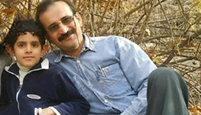  'Gholamreza Khosravi seen here with his son'