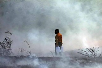 Sitting on an ocean of oil, Iran firemen have water buckets to put out fire