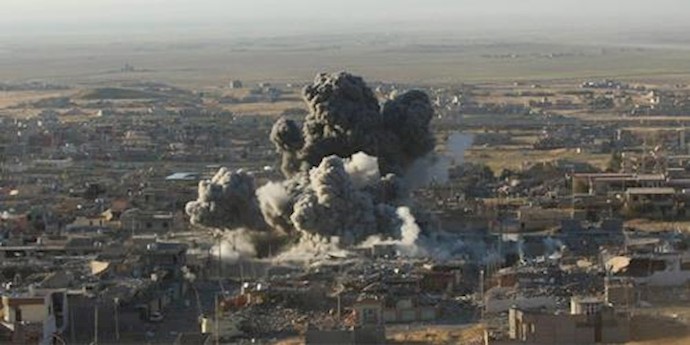  'Smoke rises from the site of U.S.-led air strikes against ISIS in the town of Sinjar, November 12, 2015.'
